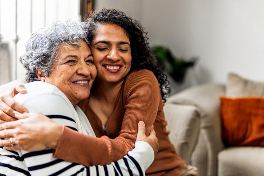 Senior woman and younger woman hugging
