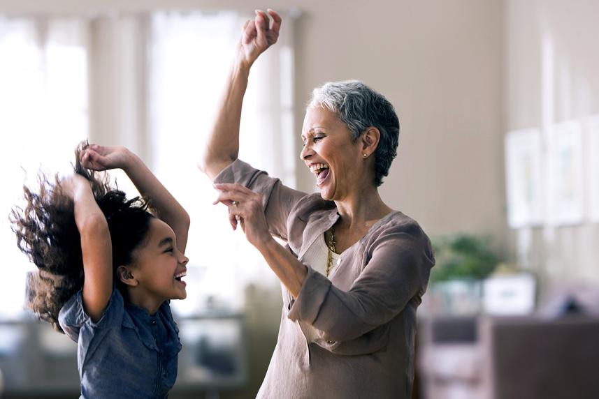 Mature woman dancing with young granddaughter