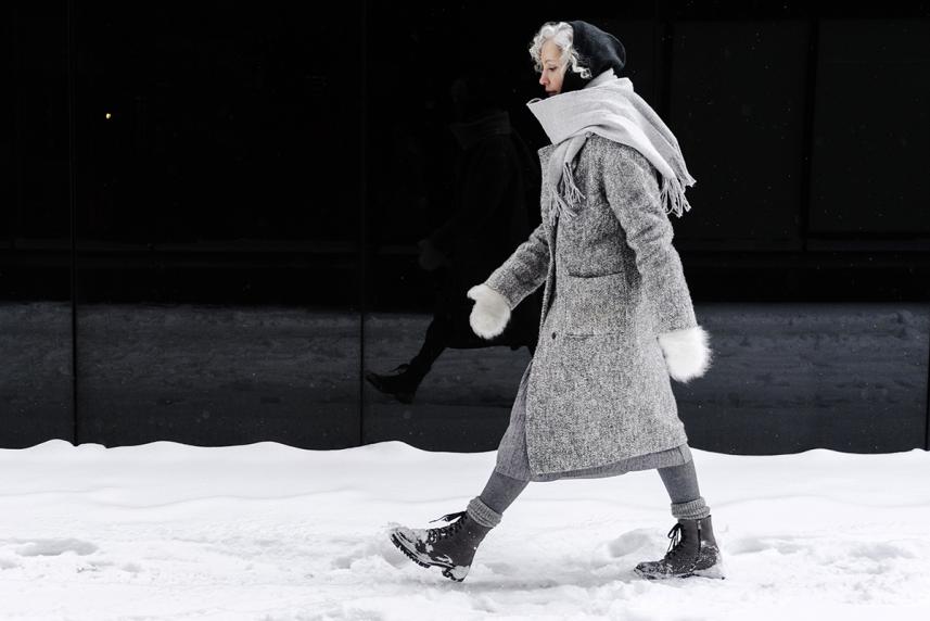 Woman, bundled up, walking outside on cold, winter day