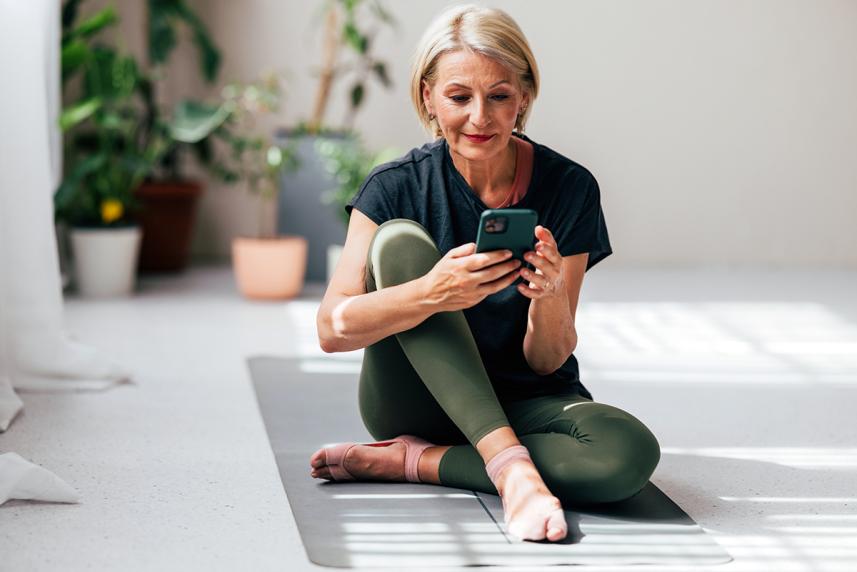Woman sitting on floor looking at cell phone
