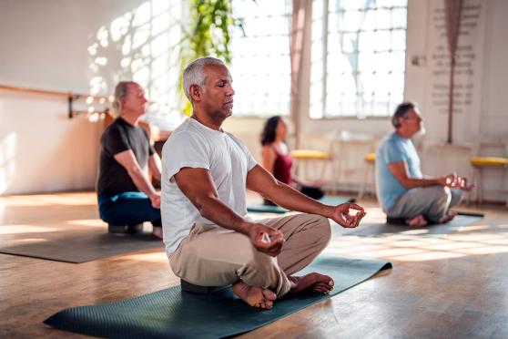 Group of people doing yoga and meditating