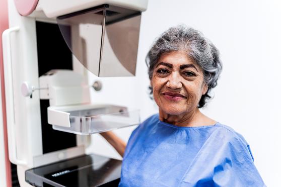 Mature woman smiling and waiting to get a mammogram