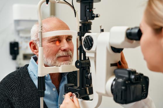 An older white man gets his eyes checked